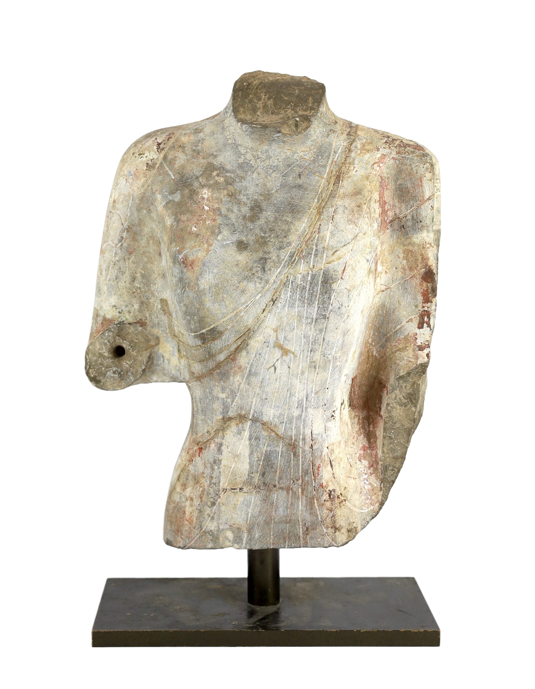 A Chinese pigment painted limestone torso of Buddha, probably Northern Qi dynasty (550-577 CE), 36cm high, mounted on a later base, total height 42.5cm